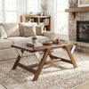 Farmhouse center table in walnut with decorative nailhead accents, featuring a spacious tabletop and stable H-shaped.