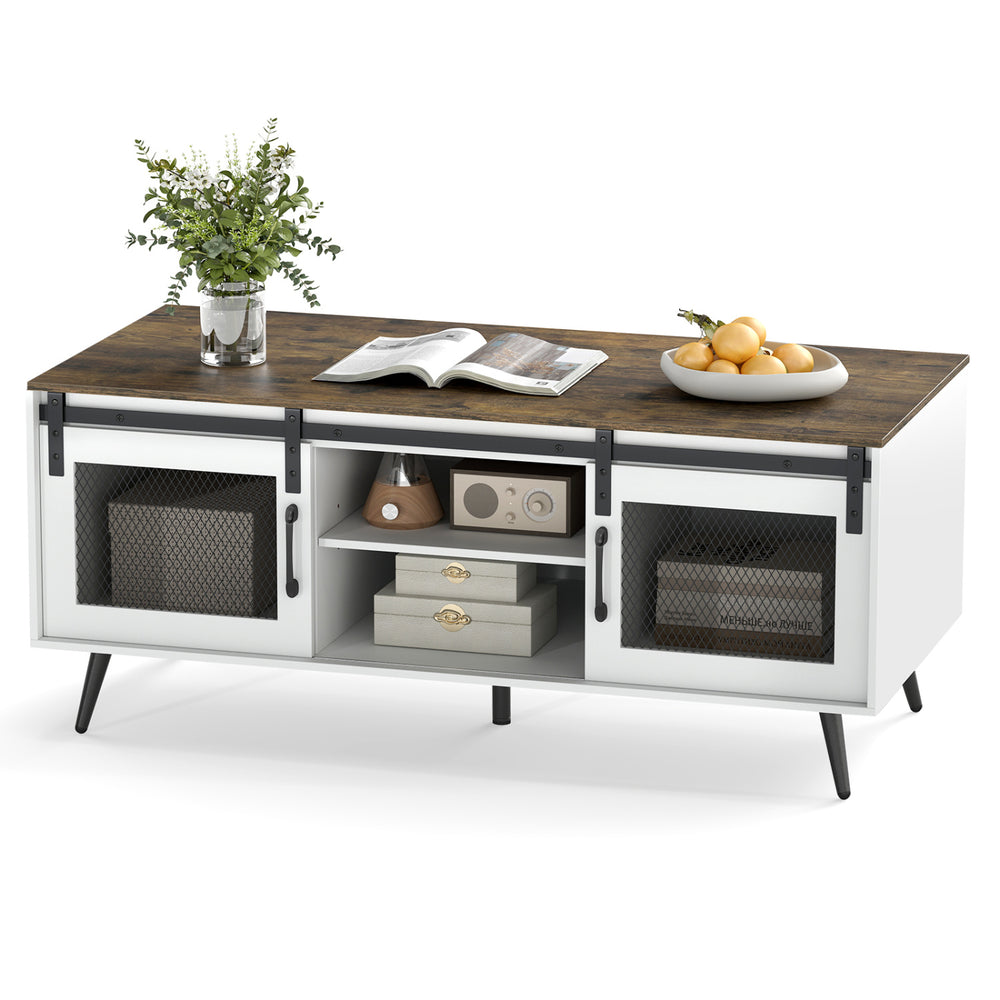 Farmhouse coffee table with rustic brown top, sliding doors, and adjustable shelf for versatile storage solutions.