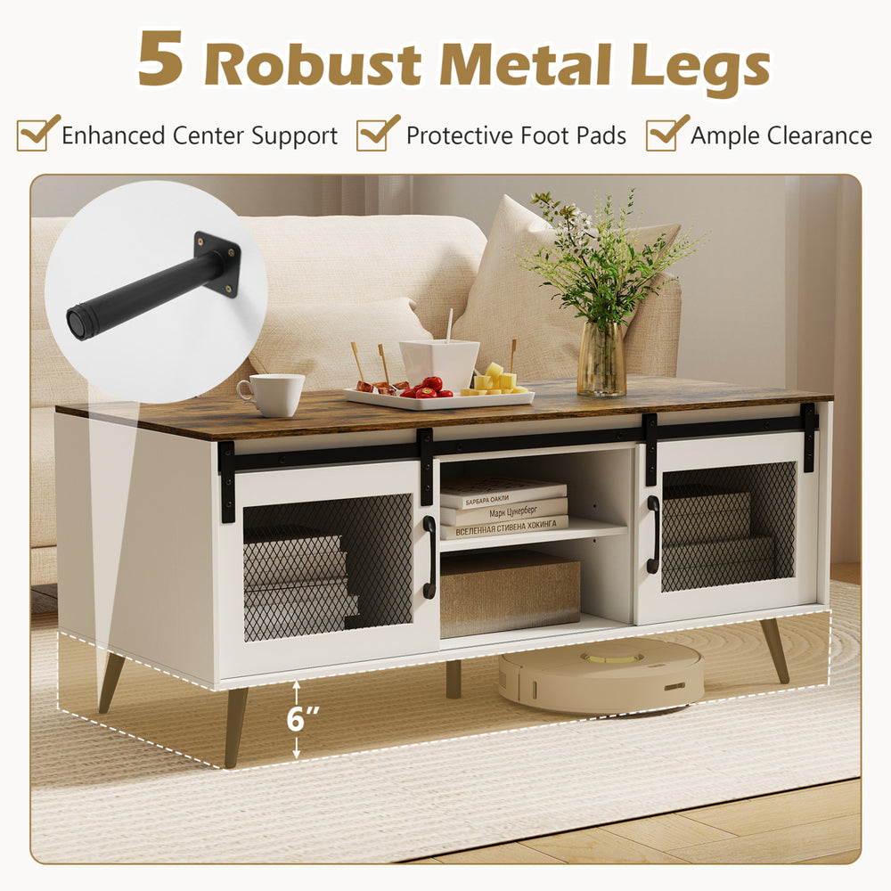 Farmhouse coffee table with sliding doors, rustic brown finish, adjustable shelf, and robust metal legs for enhanced.