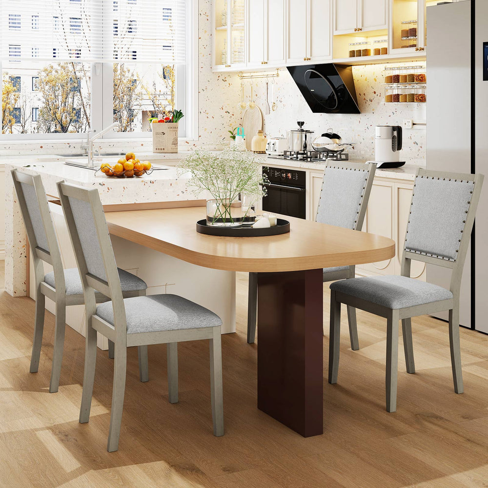 Grey fabric upholstered dining chairs with rubber wood frame and vintage nailheads, perfect for rustic and modern.