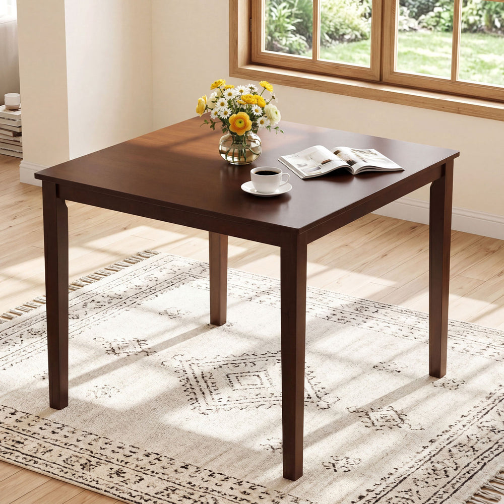 Square dining table with rubber wood legs, paired with armless chairs, ideal for space-saving in dining rooms.