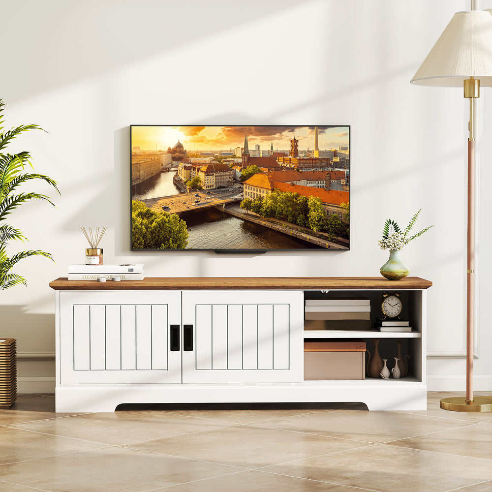 Farmhouse TV stand in white with wood top, showcasing sliding doors and adjustable shelves for stylish storage.