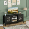 Farmhouse TV stand in black with geometric glass doors, holding a 65" TV, featuring 4 adjustable shelves for media.