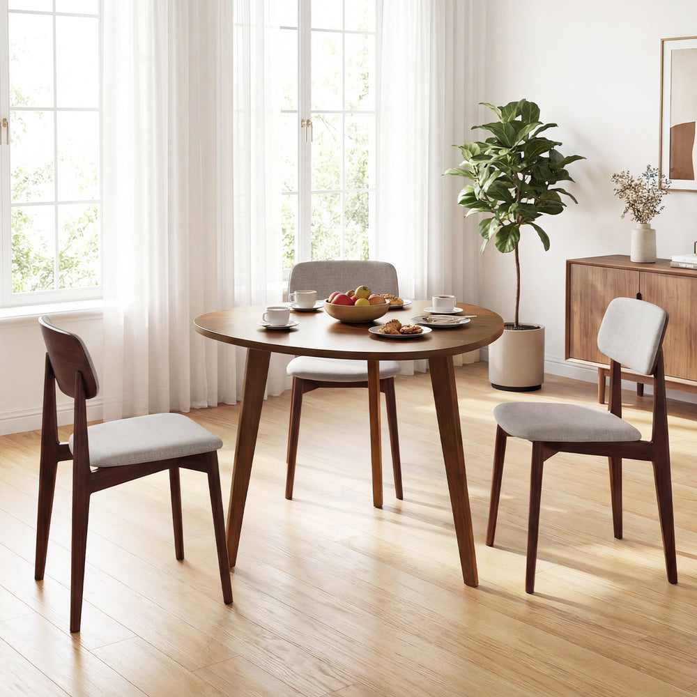 Round walnut dining table for 4 with rubber wood legs, featuring a smooth surface and vintage design, ideal for cozy.