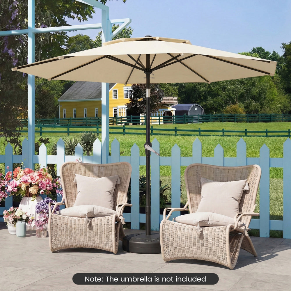 Heavy-duty black umbrella base filled with sand, designed for stability with center-pole umbrellas in outdoor settings.