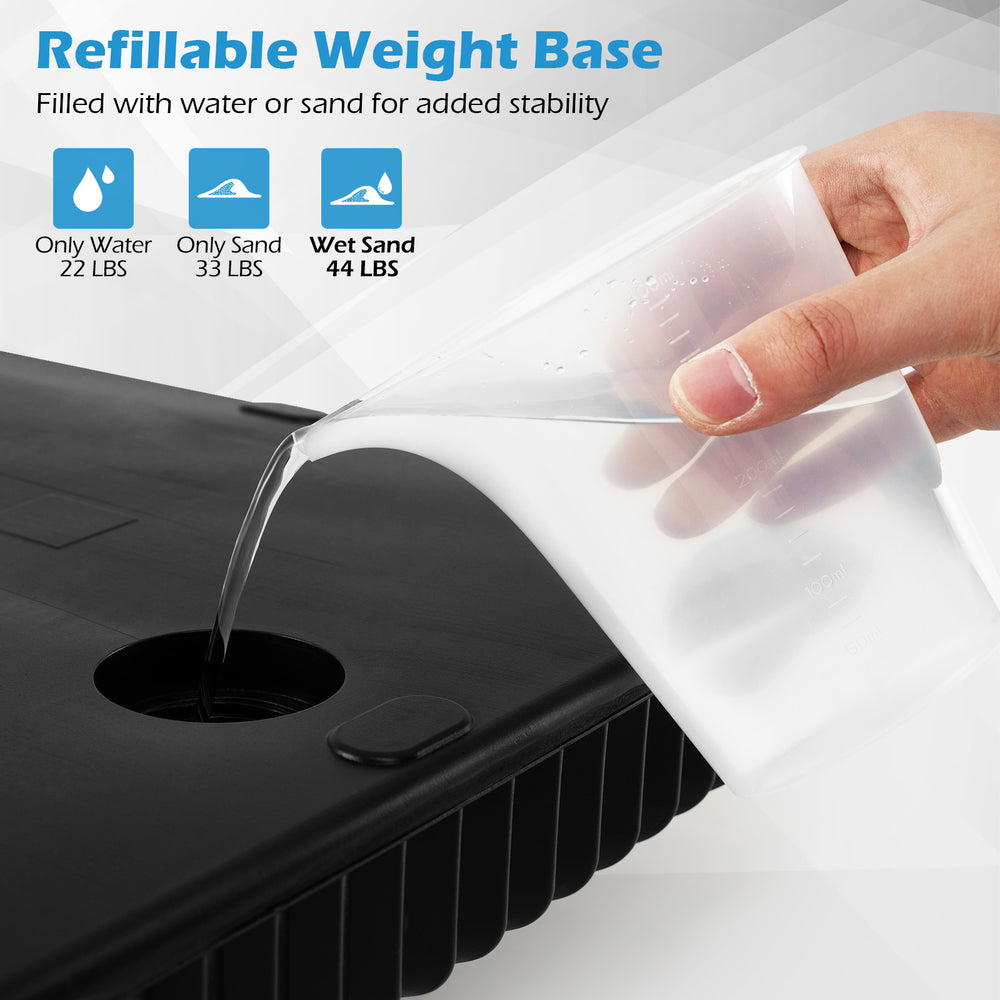 Refillable umbrella base in black, showing water being added for stability, fits 6-10 ft patio umbrellas.