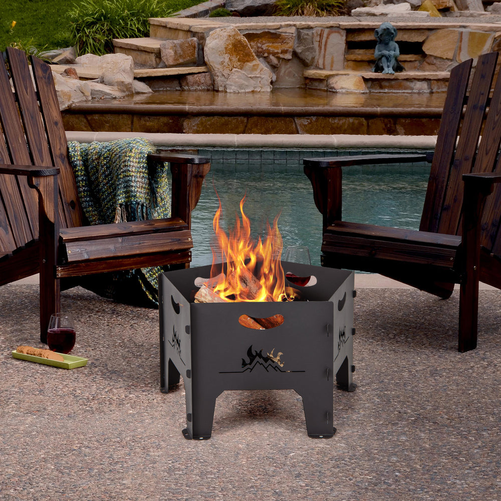 Collapsible 19-inch portable fire pit with decorative patterns, set up for a cozy bonfire by the poolside.