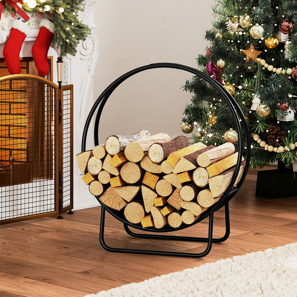Curved 20-inch firewood log hoop in black metal, neatly storing logs for indoor or outdoor use by the fireplace.