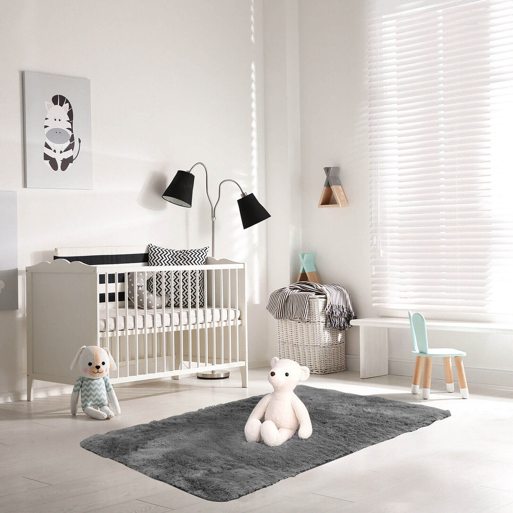 Soft shag rug in gray, 4x6 feet with non-slip grip dots, perfect for a cozy nursery or playroom decor.