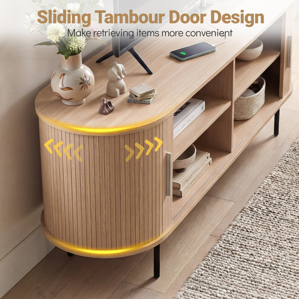 Fluted TV stand with curved design, featuring sliding tambour doors and multiple storage compartments for organization.