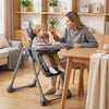 Foldable high chair in gray with detachable cushion, adjustable height, and safety harness for babies and toddlers.