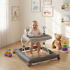 Foldable baby walker in gray with adjustable height, removable seat, and feeding tray for kids aged 6-12 months.