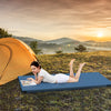 Foldable camping mattress in navy shown outdoors, featuring a plush cover and high-density foam for comfortable resting.