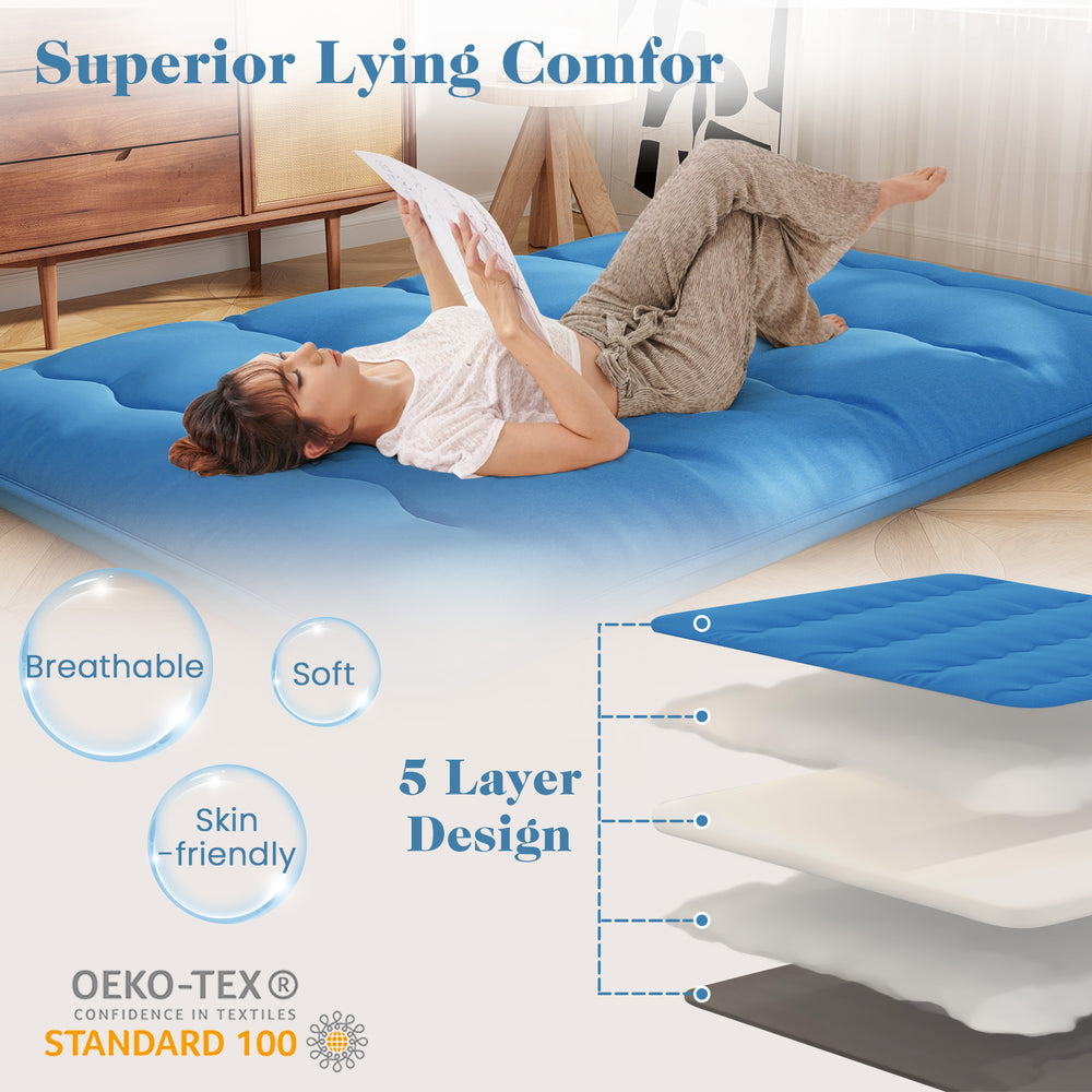 Foldable blue futon mattress with a soft, washable cover, ideal for camping, dorms, or as a play mat.
