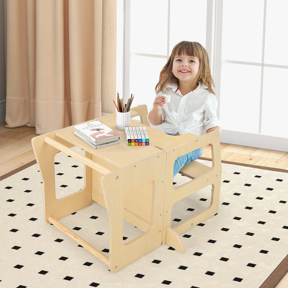 Toddler using the 3-in-1 foldable kitchen standing tower as a weaning table and stool, made of natural wood.