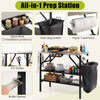 Foldable outdoor cook station with stainless steel top, removable shelves, trash bag holder, and spice rack for camping.
