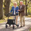 Foldable rollator walker for seniors in black, featuring a comfortable seat and adjustable handrails, perfect for.
