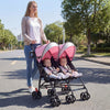 Twin baby stroller in pink with adjustable backrest and ventilated canopy, perfect for travel with two kids.