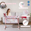 Folding baby bassinet bedside sleeper in pink with breathable mesh cloth, adjustable height, and detachable side rail.