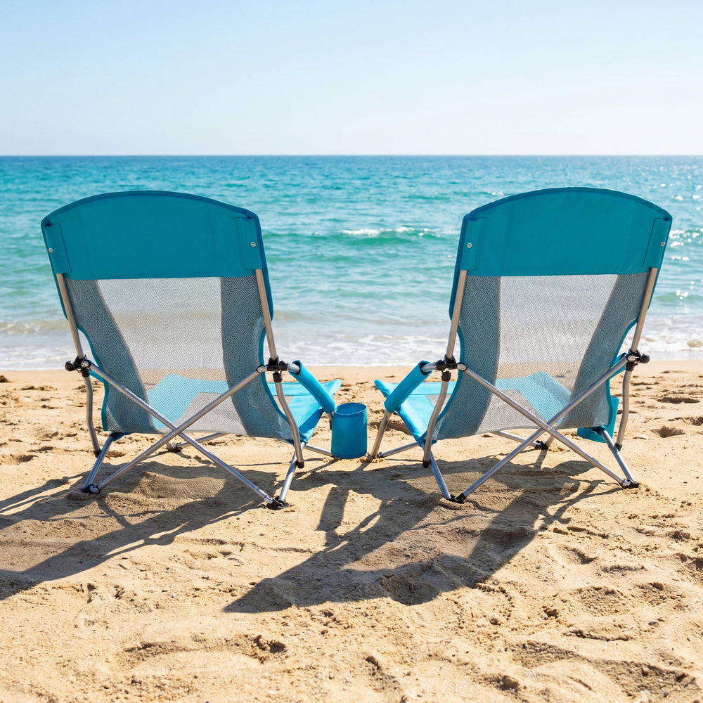 Two blue folding beach chairs with padded armrests and mesh fabric, perfect for relaxing by the ocean.