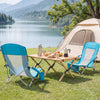 Two blue folding beach chairs with padded armrests set up by a lake, perfect for camping and outdoor relaxation.