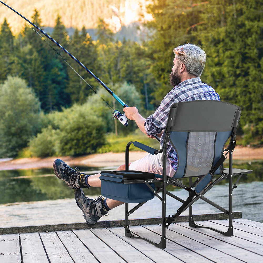 Folding camping director's chair in blue with cooler bag and side table, perfect for outdoor fishing trips.