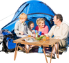 Folding camping table with waterproof surface, set up for a picnic, featuring a sturdy frame and portable storage bag.