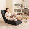 Folding floor chair in black with adjustable backrest, perfect for reading or relaxing in any space.