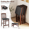 Folding bar stool set with padded seat, brown rubber wood legs, and flip-up design for space-saving storage.