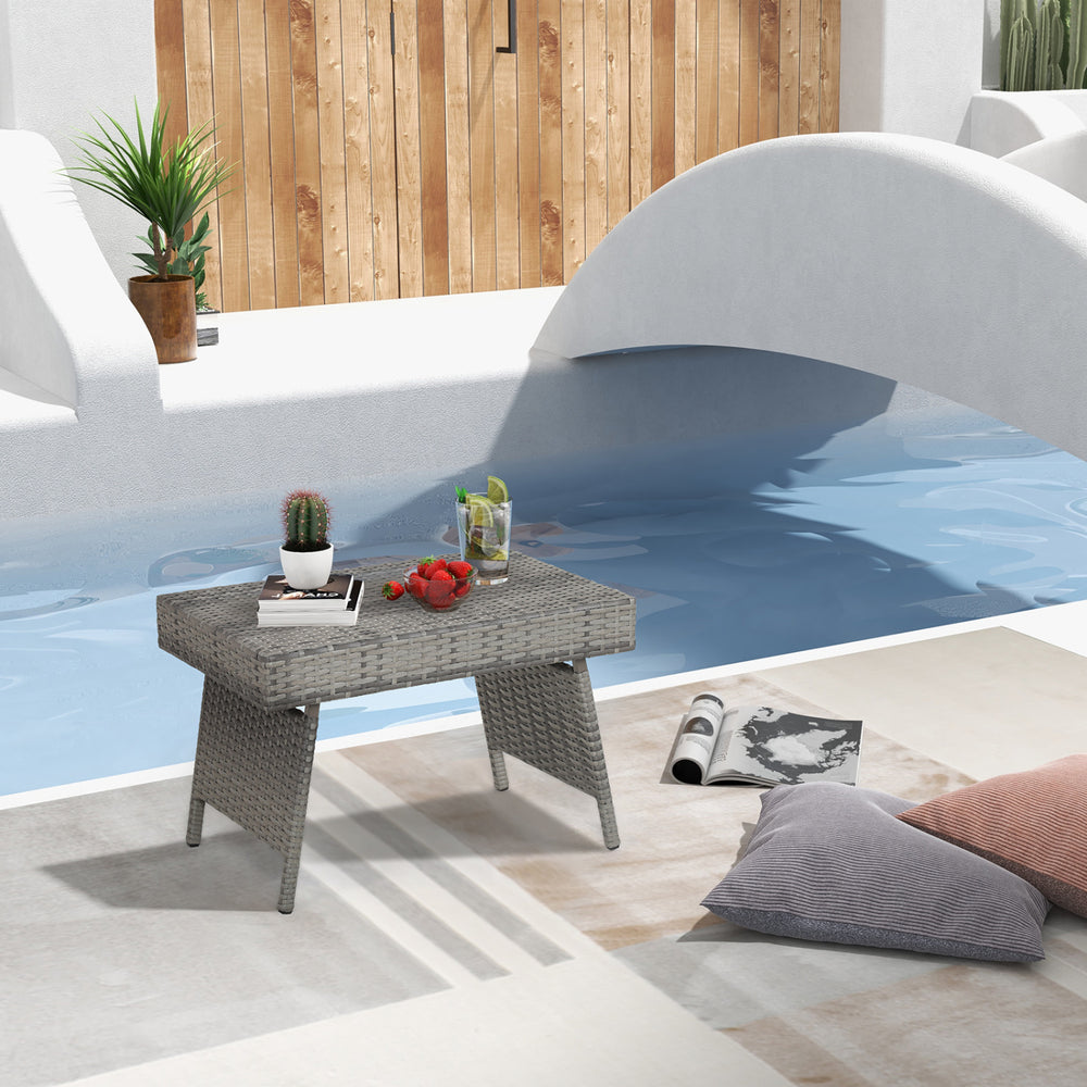 Folding gray PE rattan coffee table with wide top, perfect for outdoor use by the poolside or patio.