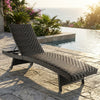 Folding padded rattan patio chaise lounge with adjustable backrest, perfect for poolside relaxation and comfort.