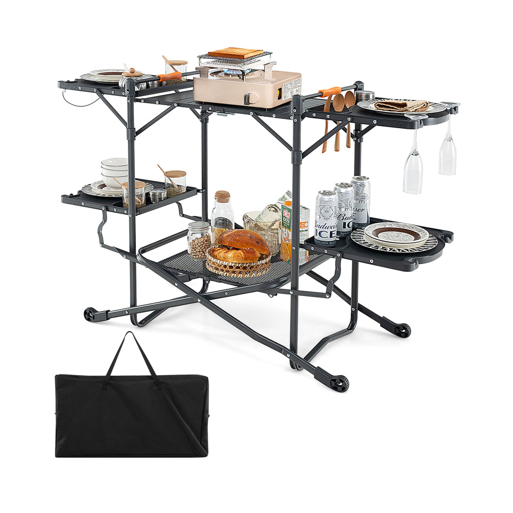 Folding portable outdoor cook station with heat-resistant aluminum tabletop, featuring multiple storage racks and hooks.