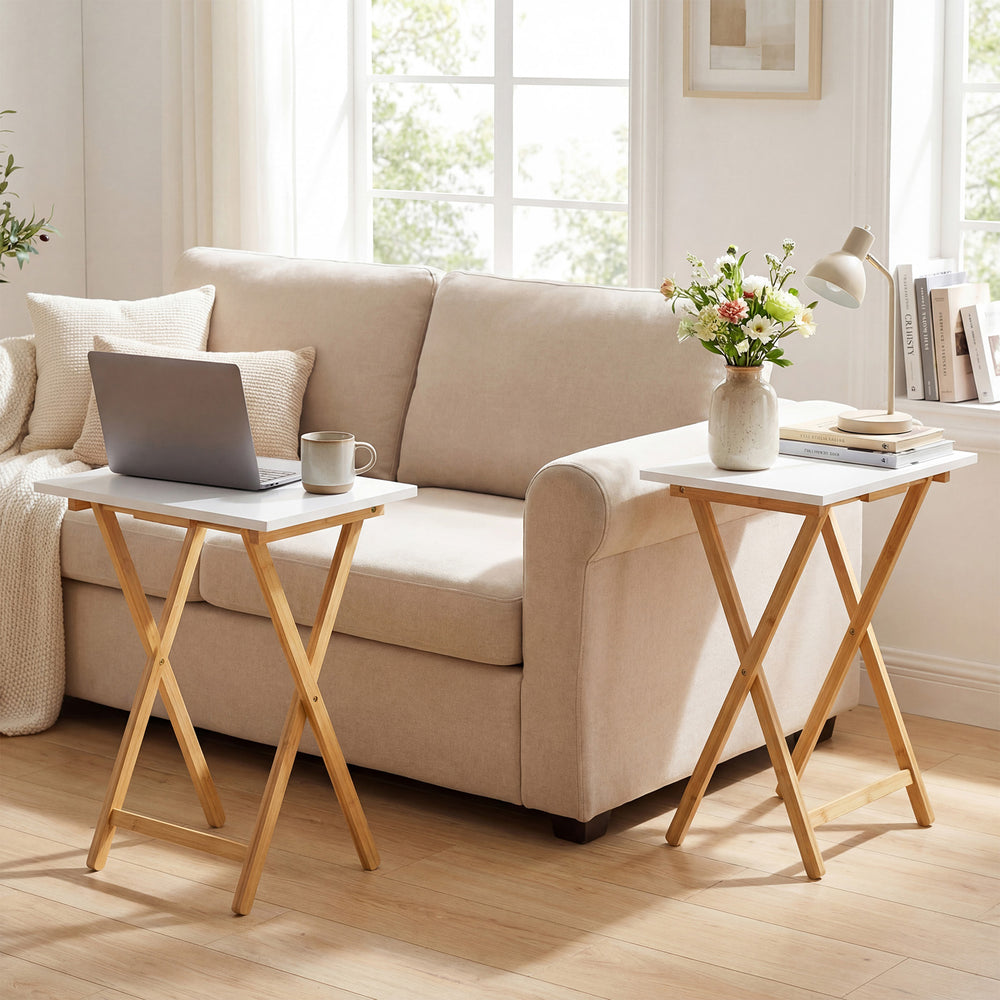 Folding TV tray tables set of 2 in white with bamboo structure, perfect for small spaces in living room or bedroom.