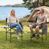 Two people enjoying the Folding Tall Director Chair with a 26-inch seat height, featuring a side table and cup holder.
