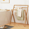 Freestanding foldable teak wood towel rack with three hanging crossbars, perfect for drying towels in any room.