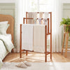 Freestanding solid wood towel rack with teak oil finish, featuring three tiers for organized towel storage in any room.