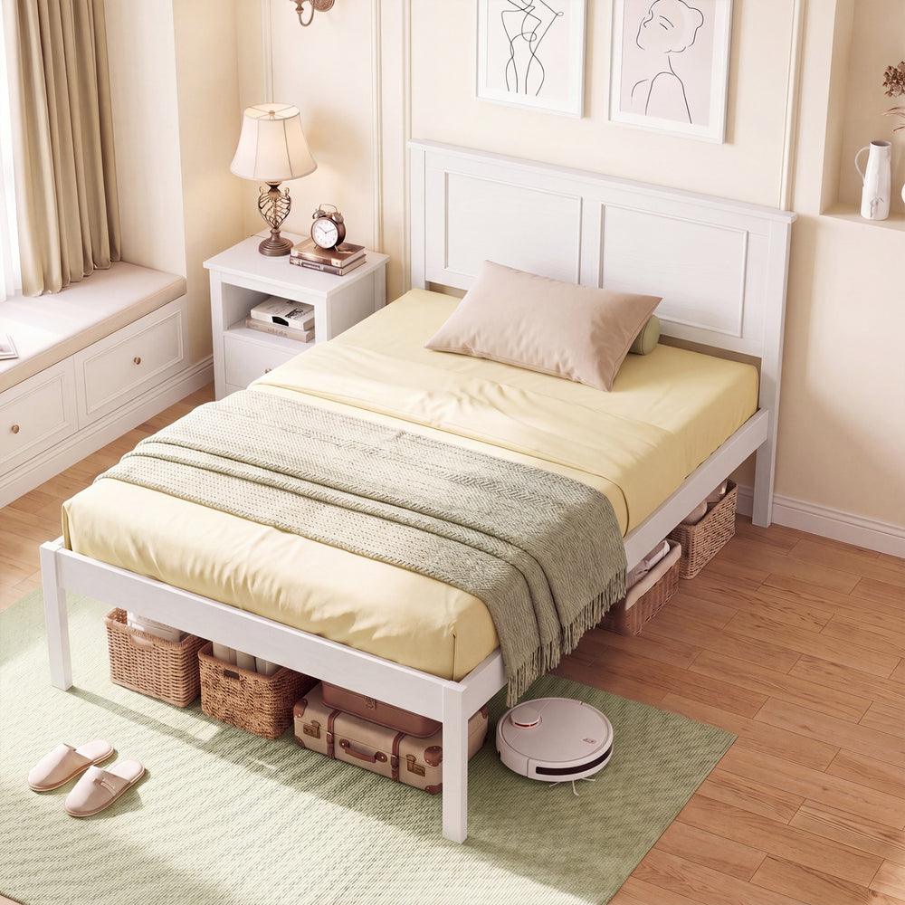 Twin size farmhouse wooden platform bed frame in white with headboard, styled with yellow bedding and decorative.
