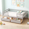 Full size gray daybed with fence and two pull-out drawers for organized children's storage and safety.