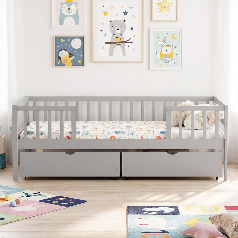 Full size gray daybed with fence and two pull-out drawers, ideal for children's storage and safety.