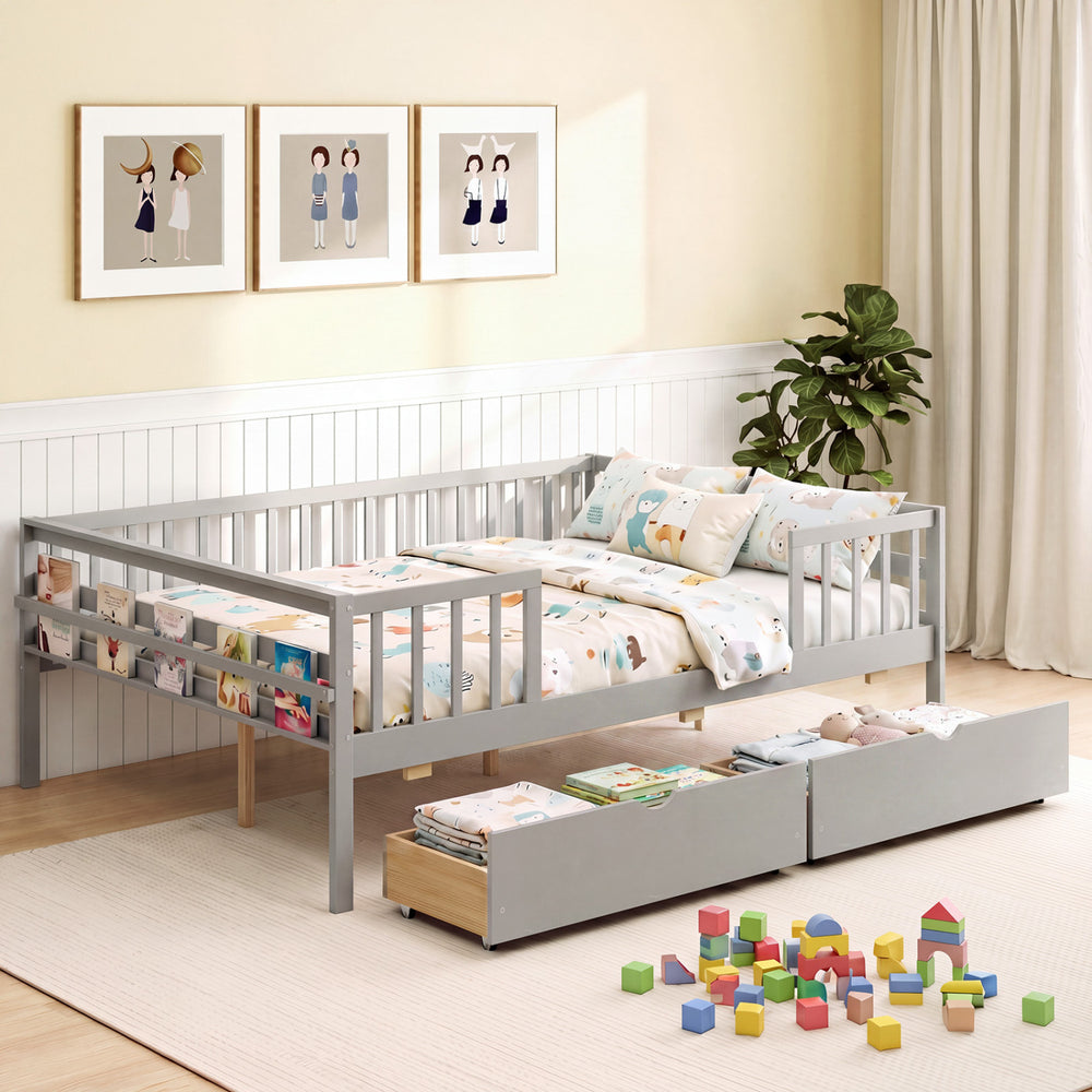 Full-size gray daybed with fence and two pull-out drawers, featuring side storage for children's items and safety.