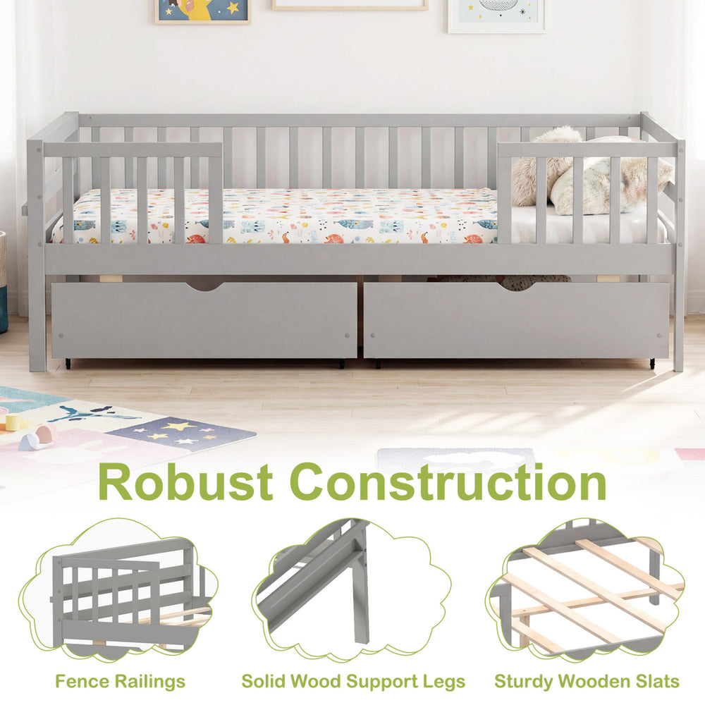 Full size gray daybed with fence, two pull-out storage drawers, and sturdy wooden slats for children's room.