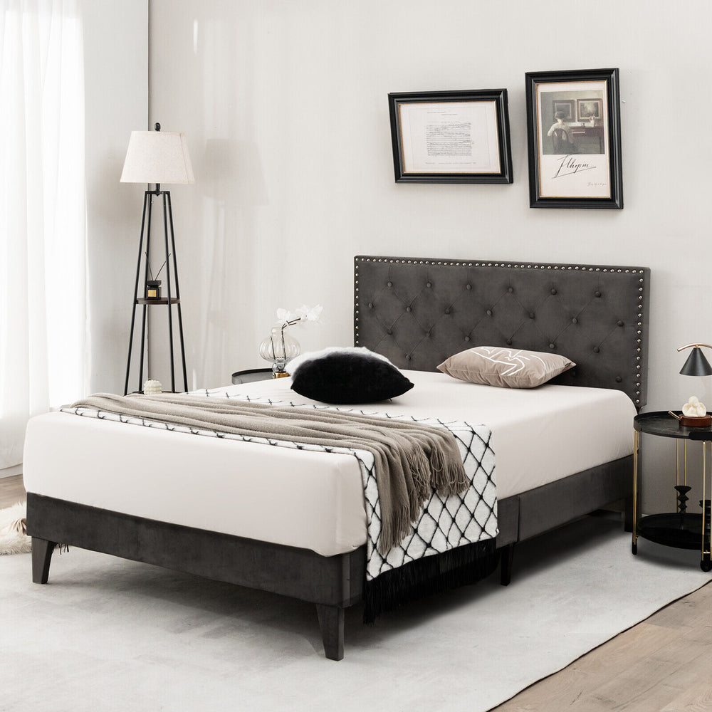 Elegant full/queen size upholstered platform bed featuring a tufted headboard and a cozy blanket for stylish bedroom.