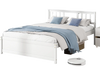 Full-size wooden platform bed in white with stylish headboard, slatted support, and elevated design for under-bed.