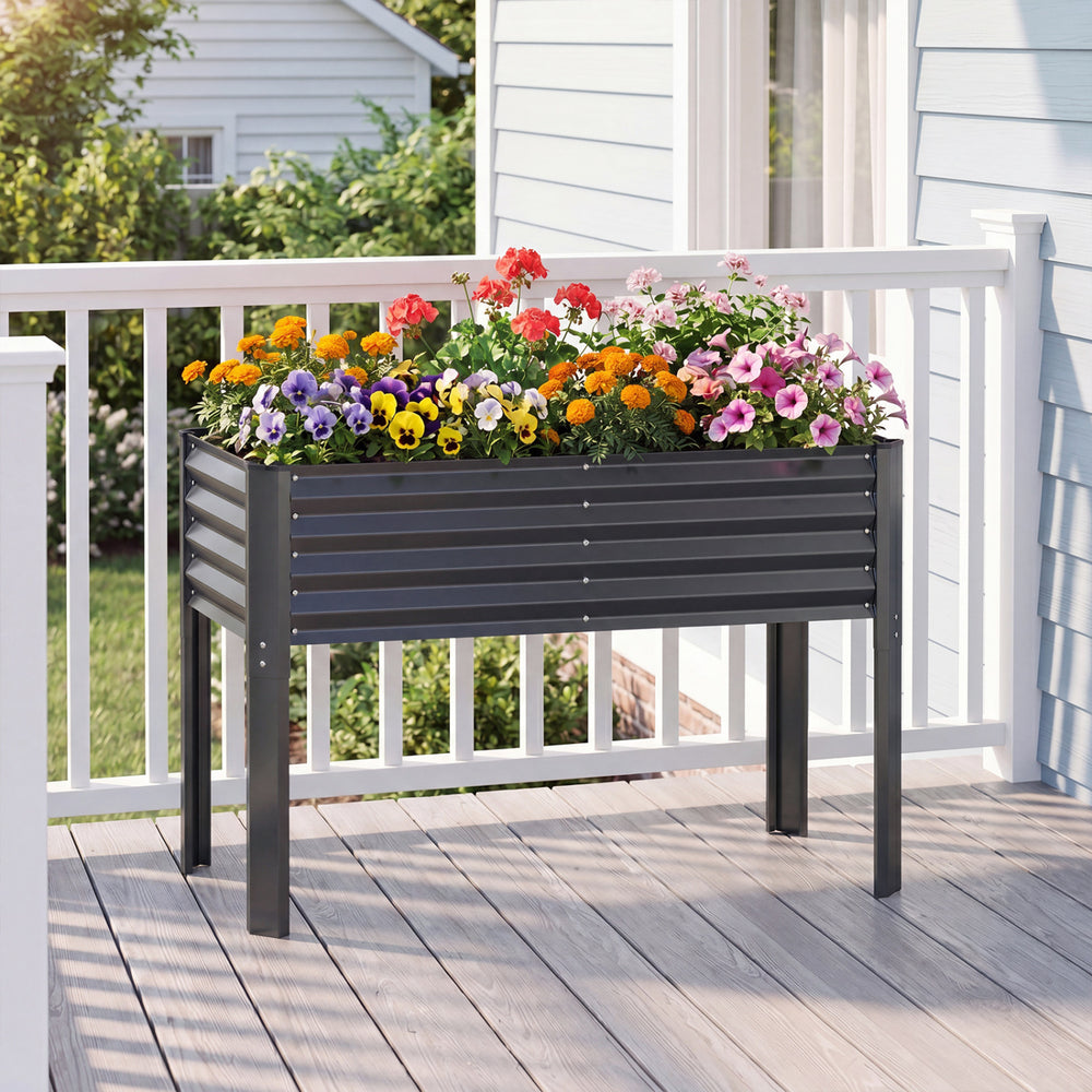 Galvanized raised garden bed with legs, 46"x24"x31", featuring vibrant flowers and ergonomic height for easy gardening.