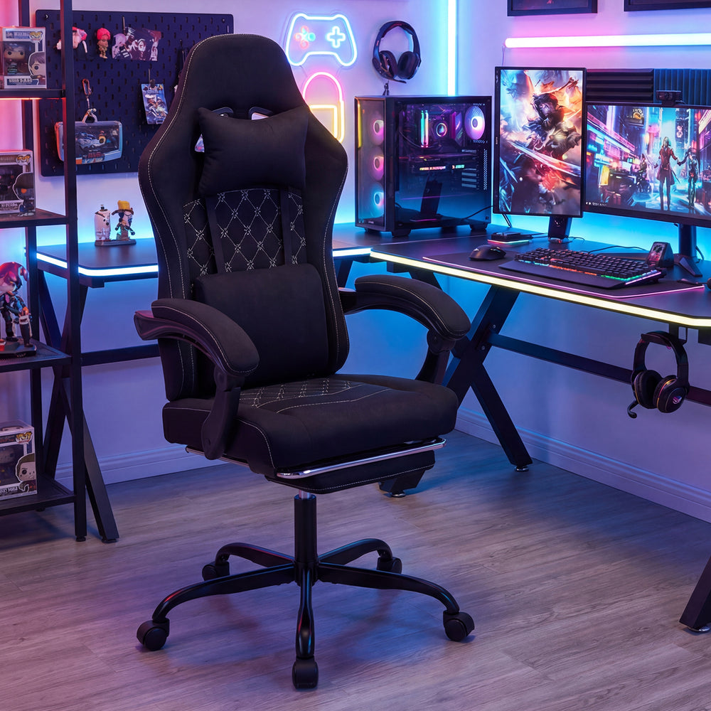 Gaming chair in black featuring a reclining backrest, padded armrests, and retractable footrest for versatile comfort.