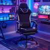 Height adjustable gaming chair in black with ergonomic design, headrest, footrest, and 360° swivel for optimal comfort.