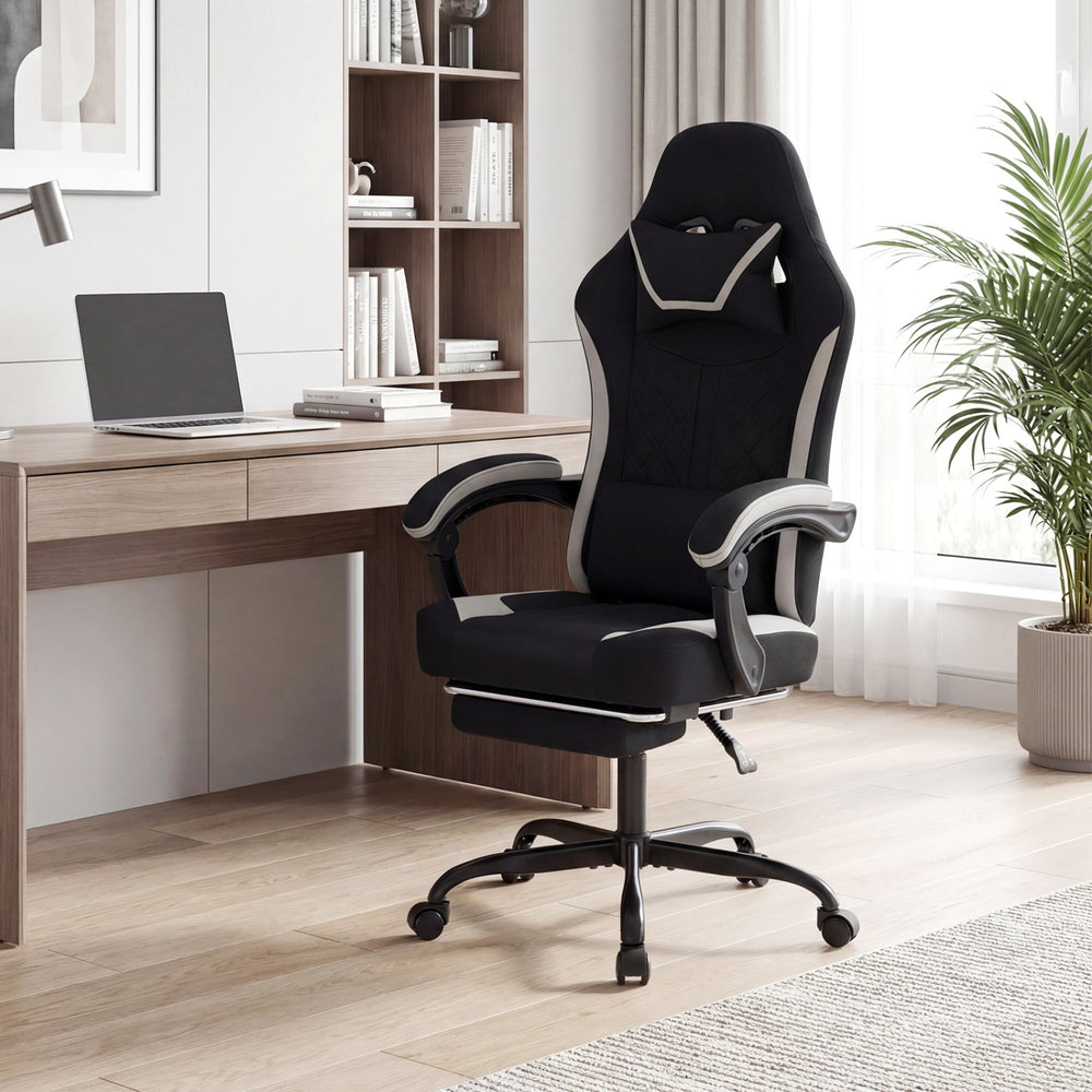 Height adjustable gaming chair in black with headrest, footrest, and ergonomic design for optimal comfort during gaming.