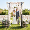 Garden arbor with gate and planter boxes, featuring a flat roof and side trellis, ideal for garden events and.