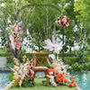 Outdoor metal garden arch trellis with floral decorations, ideal for climbing plants and event backdrops.