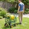 Garden hose reel cart with 300 ft capacity, green metal frame, 4 wheels, and storage basket for easy maneuvering in the.